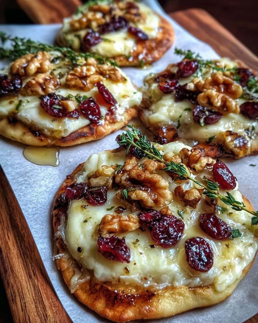 Mini Pizza with Brie Cranberries Toasted Walnuts with a Hot Honey Drizzle