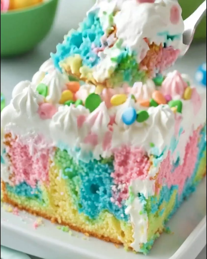 A super moist cake filled with pretty pastel pokes and topped with fluffy frosting—bright fun and guaranteed to stea