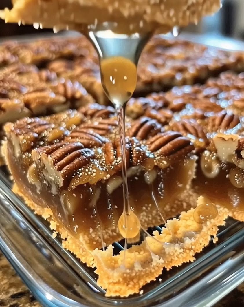 All the gooey caramelized pecan pie goodness—made the easy way with pie crust pressed into a pan and a glossy brown sug