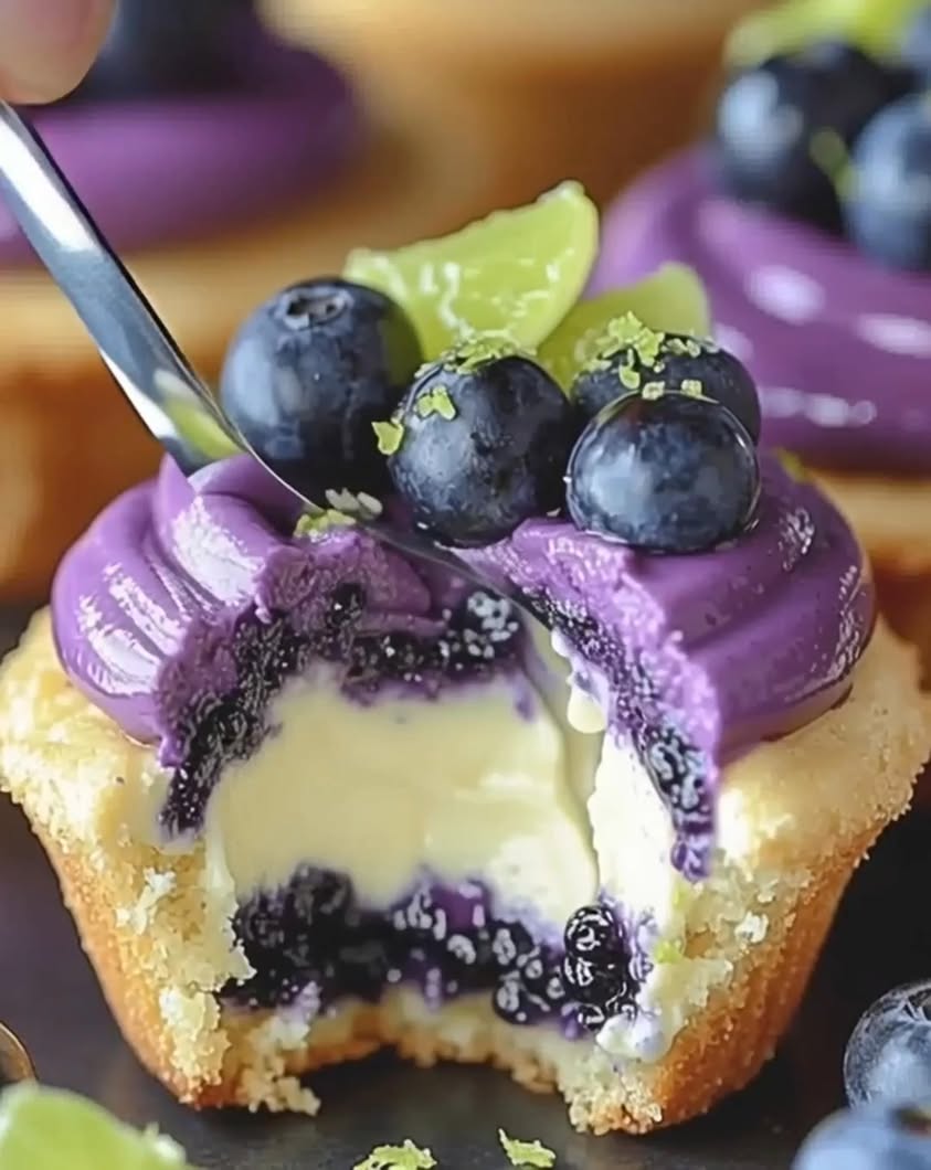 Creamy mini cheesecake cupcakes with a bright lime kick and sweet blueberry preserves on top